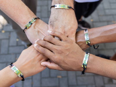 hands wearing courage bracelets